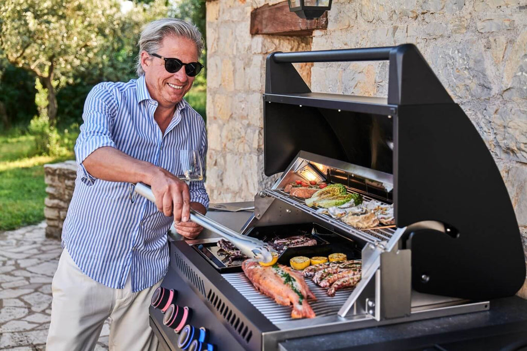 Man cooking on the Napoleon OASIS outdoor kitchen